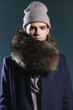 Portrait of a man with a fur scarf around his neck, looking at the camera