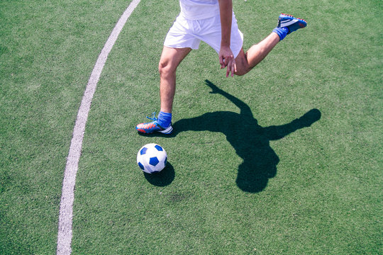 Soccer player kicking a ball during a soccer match