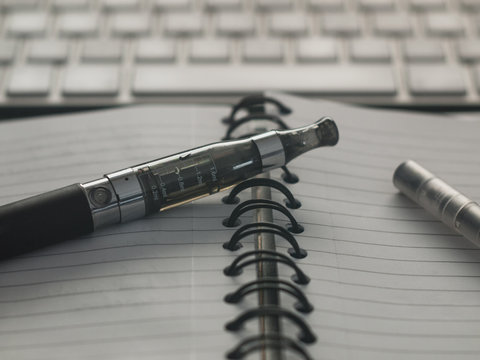 E-cigarette on notepad