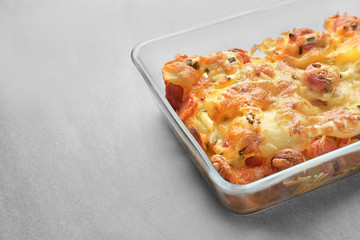 Delicious sausage casserole in baking dish on table