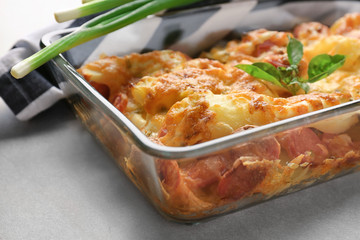 Delicious sausage casserole in baking dish on table, closeup