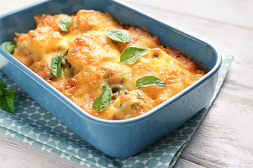 Delicious sausage casserole in baking dish on table, closeup
