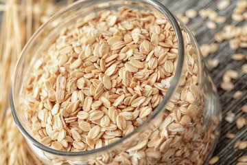 Glass jar with oatmeal flakes, closeup
