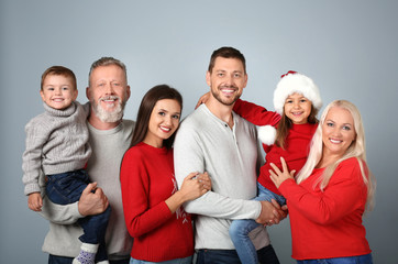Happy family in Christmas mood on light background