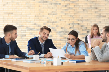 Team of young managers discussing project in office © Africa Studio