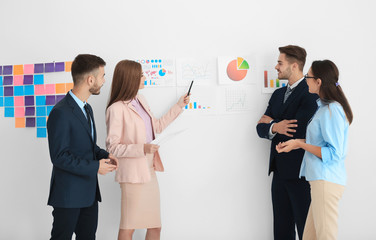 Team of young managers discussing project in office