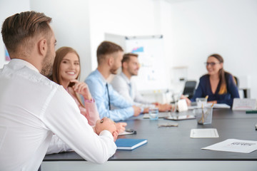 Team of young managers discussing project in office © Africa Studio