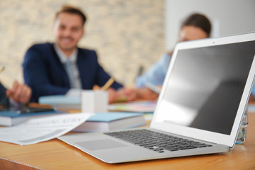 Modern laptop at table in office © Africa Studio