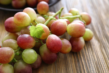 Naklejka na ściany i meble Fresh ripe grapes on wooden background