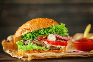 Tasty beef burger on table