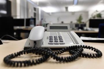 Old used business telephone in an empty office
