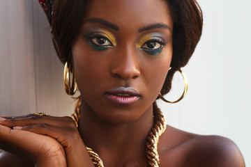 Beautiful dark skin afro girl with professional make-up and gold jewelry - 178029150