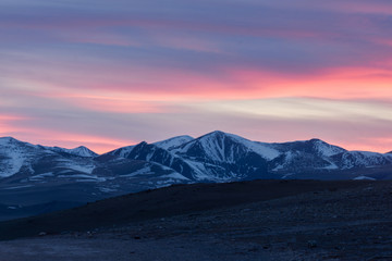 picturesque landscape of snow-covered mountains at sunrise
