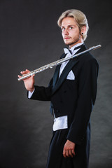Elegantly dressed musician holding flute © anetlanda