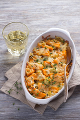 Pumpkin Gratin with leek, thyme and cheese on a gray background, selective focus