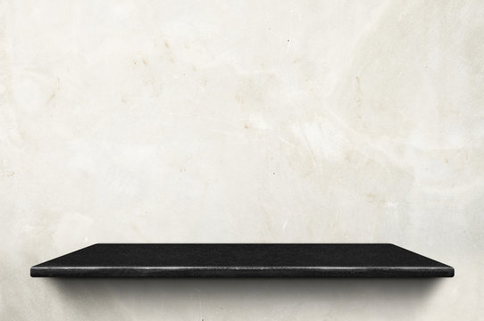 Empty black marble stone shelf at white concrete wall background,Mock up for display or montage of product or design