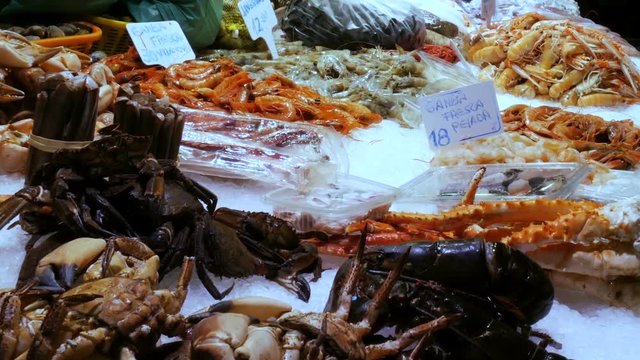 Seafood moving shrimps great lobsters and crabs on the counter market,Seafood in the market La Boqueria in Barcelona