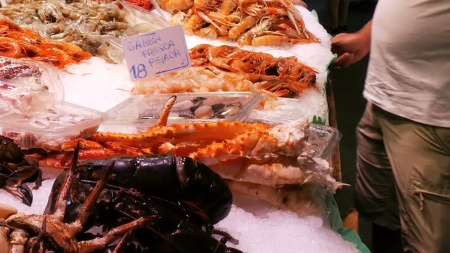 Seafood crabs lobster squid shrimps crayfish oyster mussels seashells in fish market on ice La Boqueria Spain, Barcelona