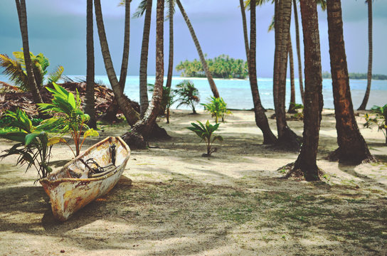 Wooden boat on the perfect tropical paradise island with turquoise water view