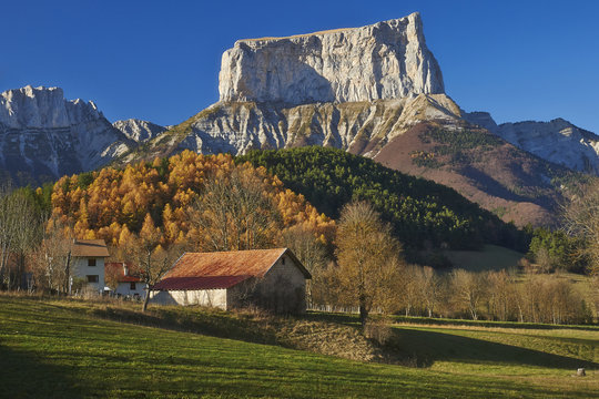 Small house in autumn Alps