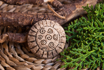 Fototapeta na wymiar Handmade jewelry background with nature decor. Bone brooch from polymer clay in macro.