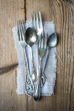 Vintage cutlery on a wooden background