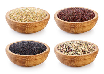 Black, red and white quinoa grains on wooden bowl.
