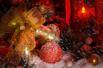 Fototapeta na wymiar golden christmas bells and Christmas toys in the light of a red lantern