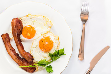 Bacon & Eggs on White Plate with Knife and Fork