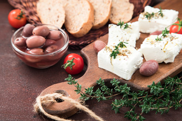 Greek cheese feta with thyme and olives.  selective focus, copy space