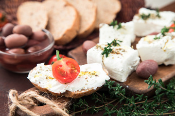 Greek cheese feta with thyme and olives.  selective focus, copy space