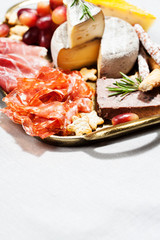Food tray with charcuterie assortment, cheese  and grapes