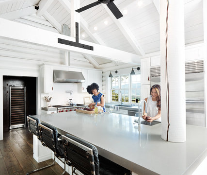 Young Women Cooking In Modern Kitchen At Home