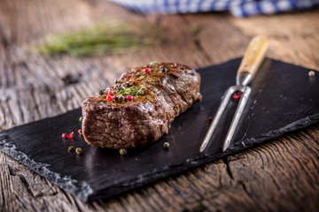 Beef Steak. Roasted Beef steak with salt pepper thyme on rustic wooden table