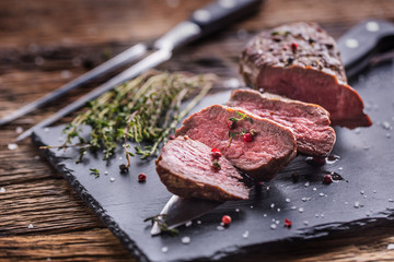 Beef Steak. Roasted Beef steak with salt pepper thyme on rustic wooden table