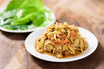 Thai food,spicy mango salad on white dish with vegetable