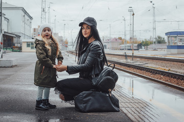 Mother and daughter at the train station