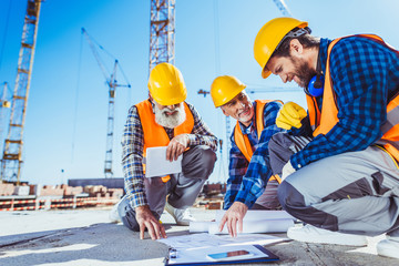 construction workers discussing building plans