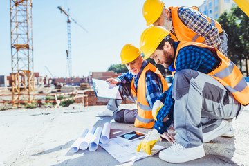construction workers looking at building plans
