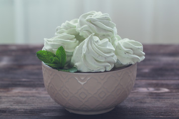Mint Marshmallow or zephyr in the bowl with a leaf of mint