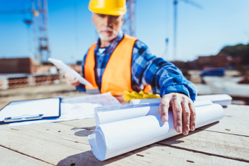 construction worker with building plans