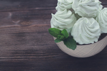 Obraz na płótnie Canvas Mint Marshmallow or zephyr in the bowl with a leaf of mint