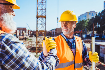 construction workers shaking hands