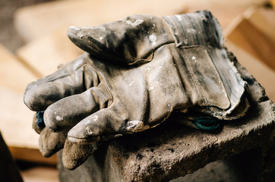 A Man's Worn Work Gloves At Rest