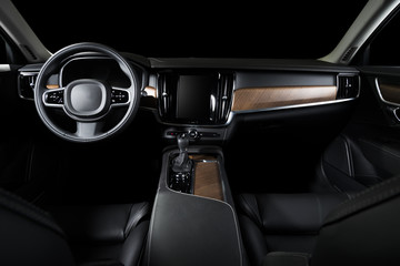 Dark luxury car Interior - steering wheel, shift lever and dashboard. Car interior luxury. Beige...