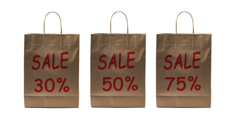 Three paper bags with sale sign and different discount