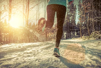 Door stickers Jogging Woman Running at snowly winter under sunlight.