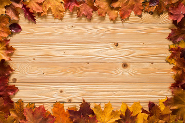 fallen leaves on wooden background, top view