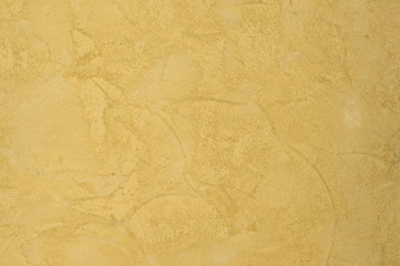 background of the plastered texture with marble effect gold color. artistic background handmade