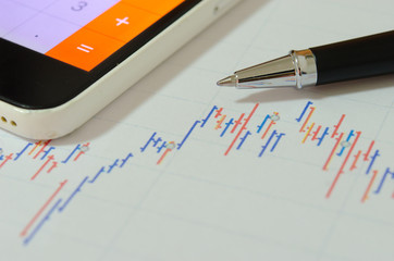 Financial graphs  and pen